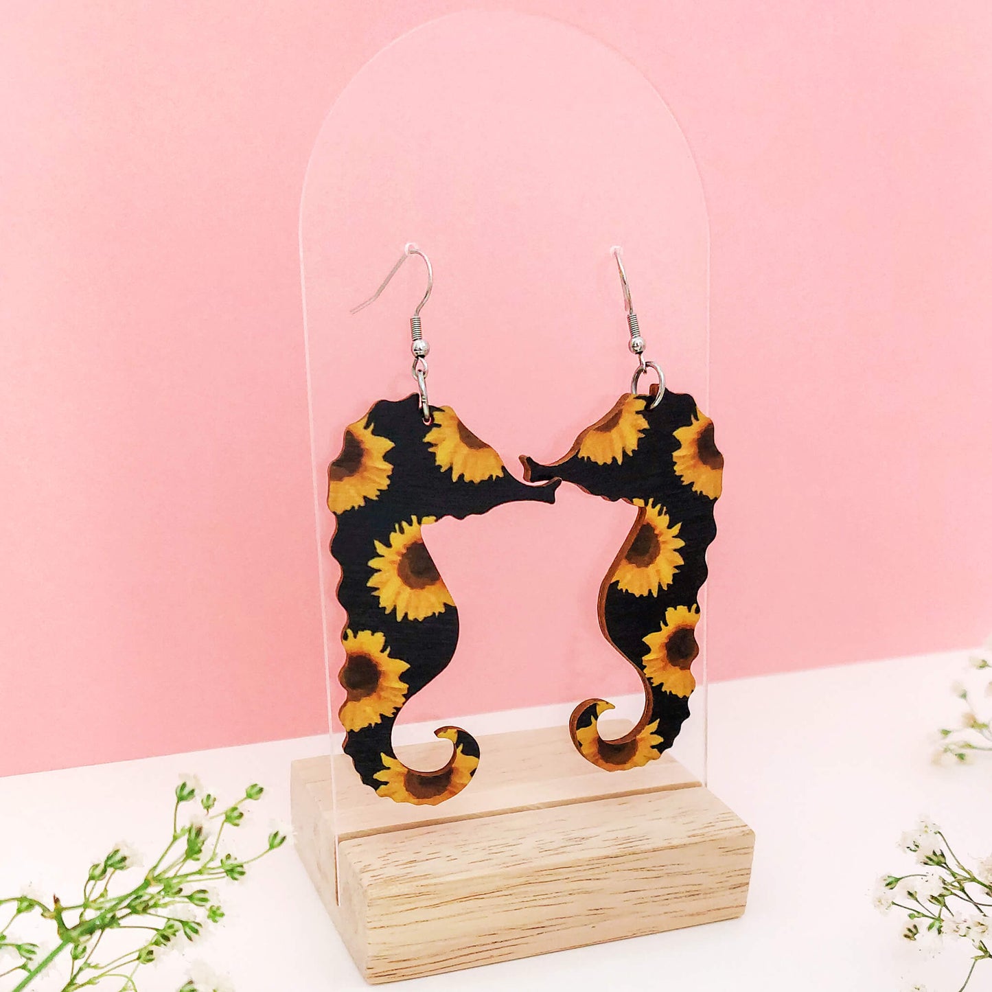 Merihevosen muotoiset puukorvakorut.